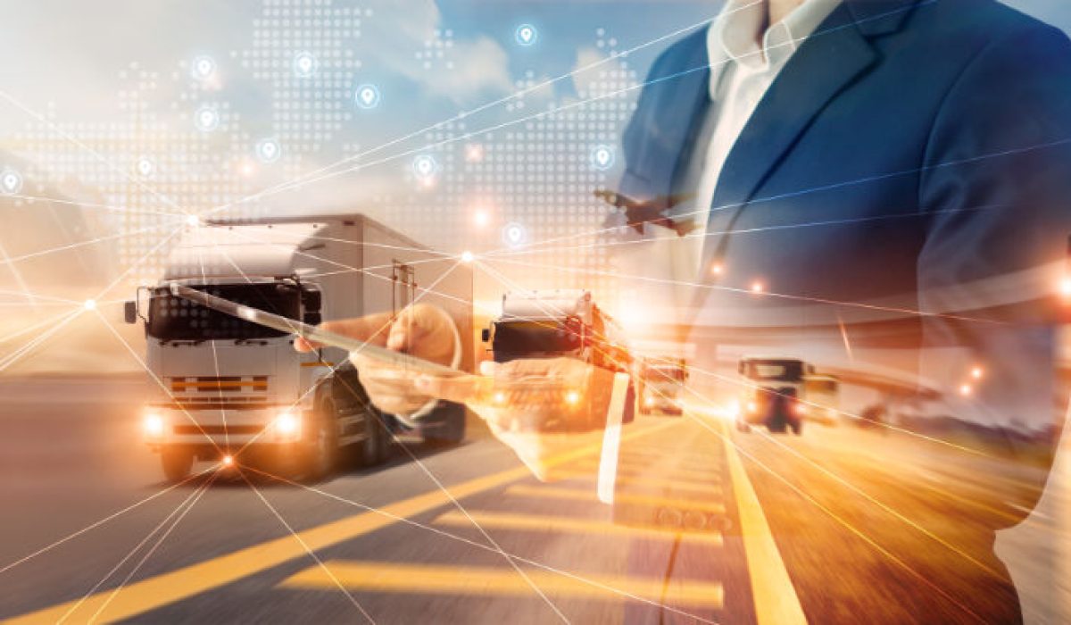 Businessman using tablet on logistic network distribution and smart transportation and networking intelligent logistics of truck and train container cargo ship, Logistic import export and industry.